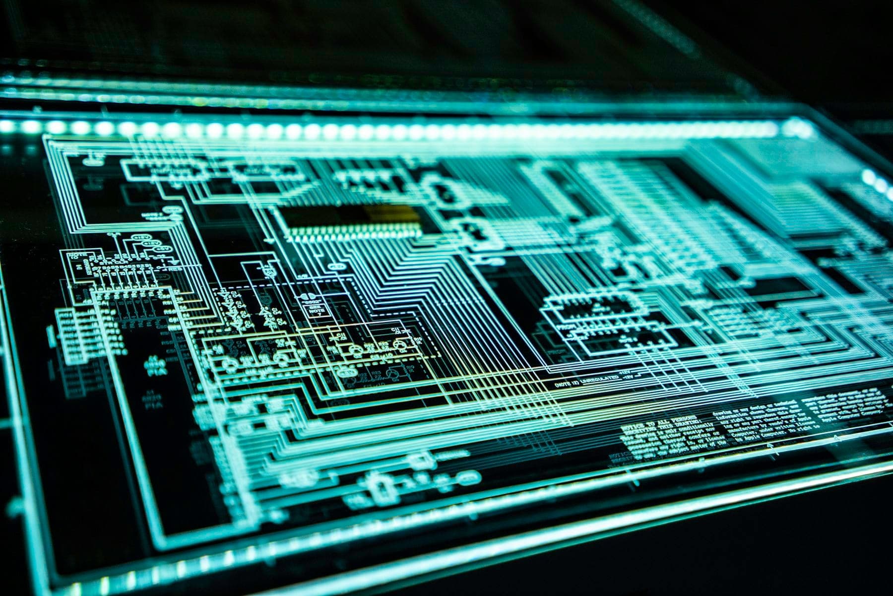 A close-up of a circuit board with glowing traces