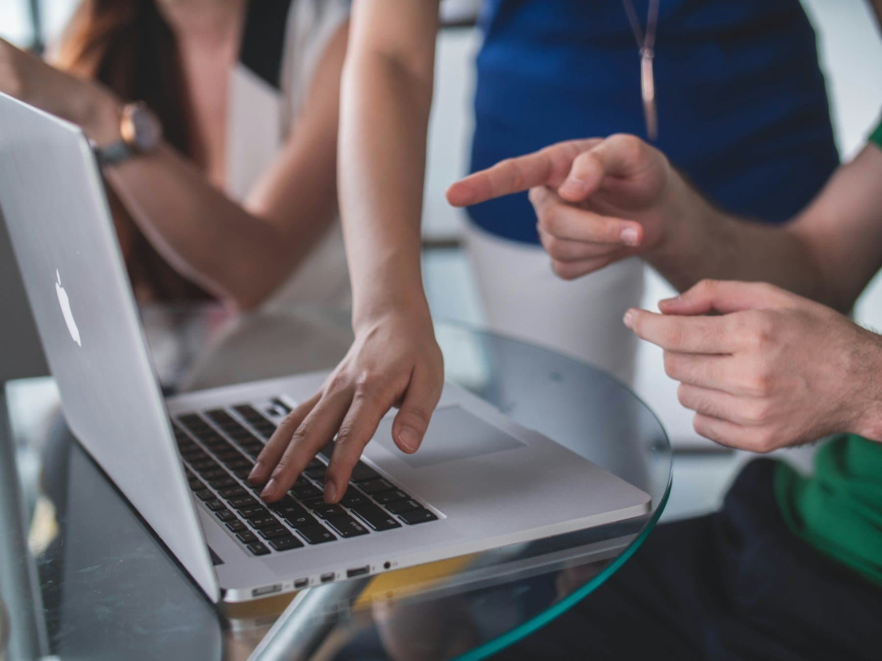 A team reviewing software options together on a laptop